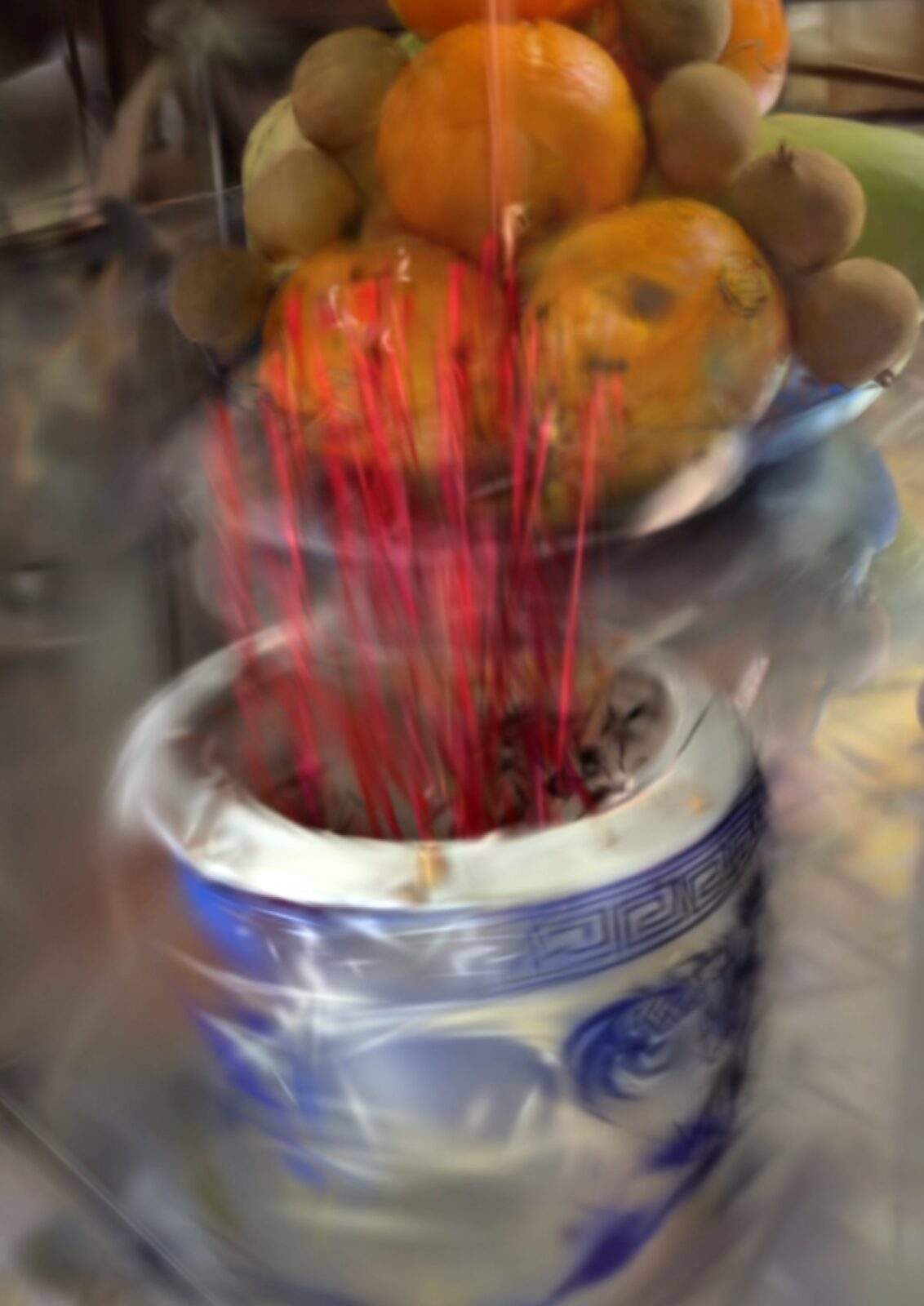Incense burning in a ceramic vessel on the family altar